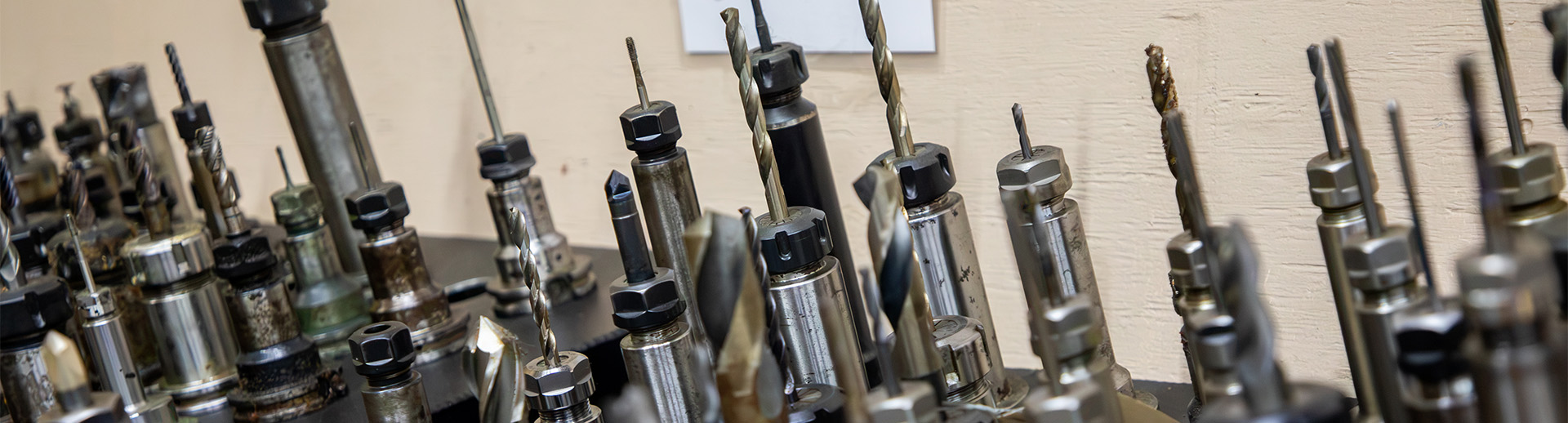 Rows of drill bits and tool holders ready for CNC production