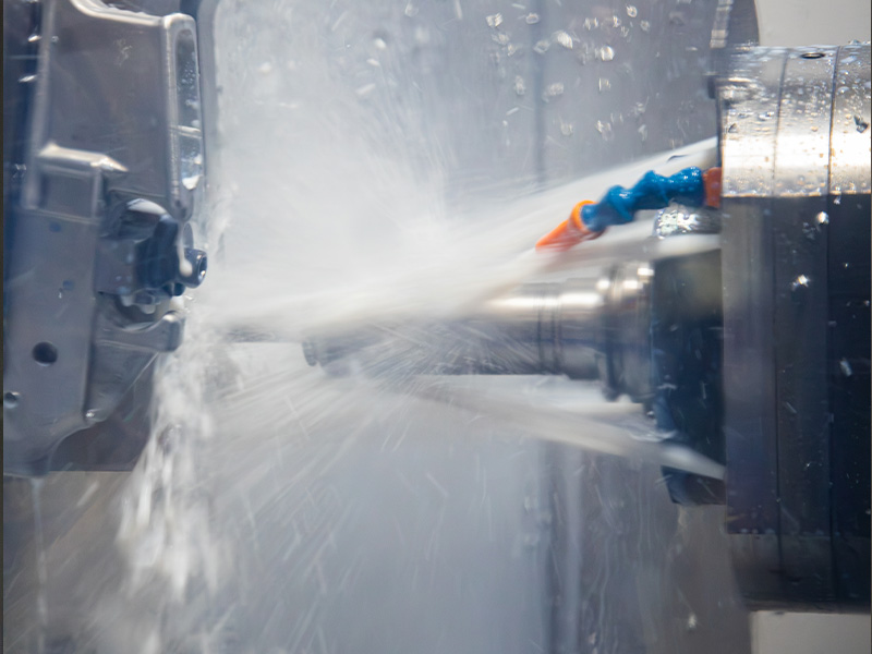 Coolant flowing over a part during CNC machining