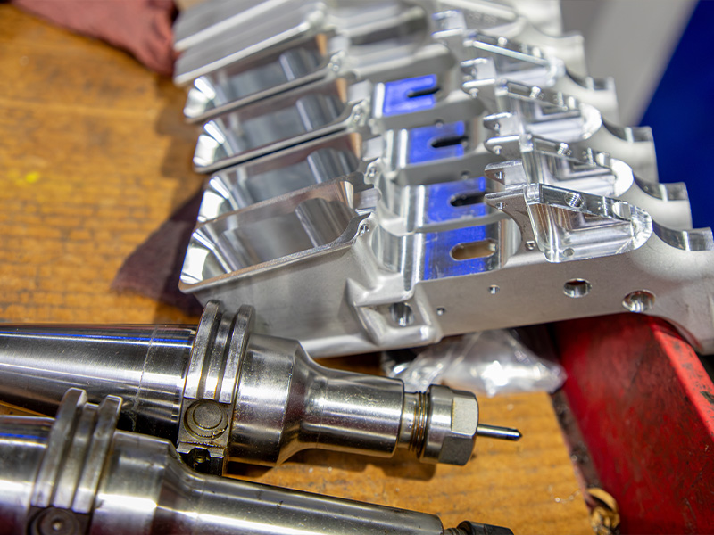 Machined components and cutting tools on a production workbench
