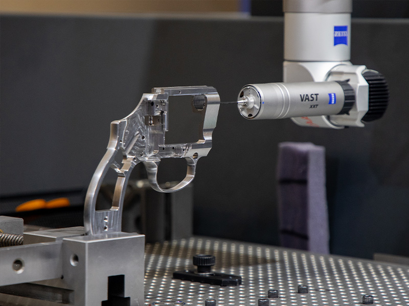 A coordinate measuring machine inspecting a machined metal component