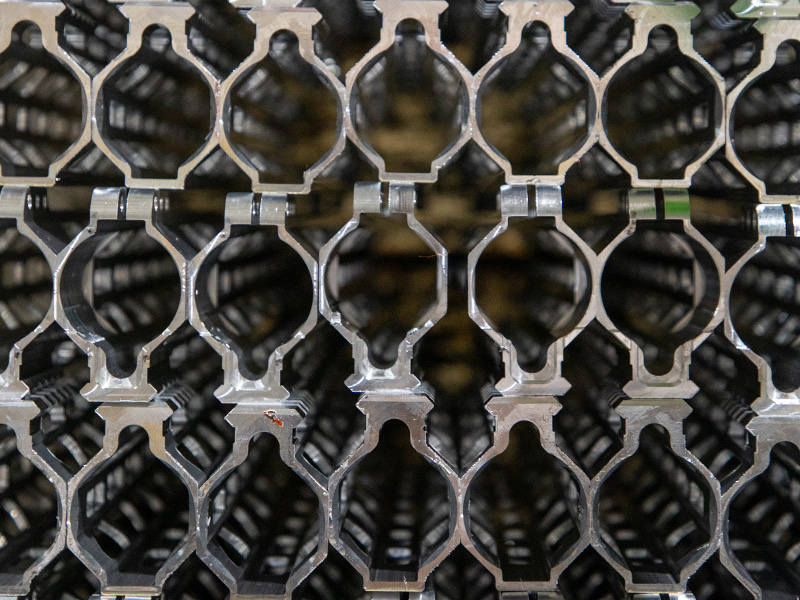 Rows of machined components on production racks