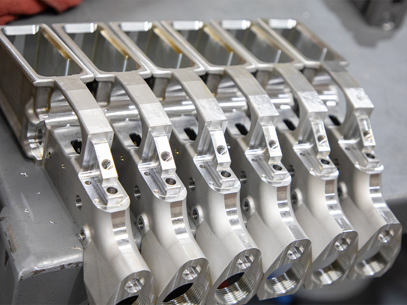 Machined metal components arranged together for inspection